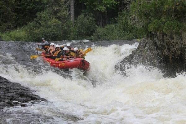 Group of People Whitewater Rafting on a Canada Falls with Northeast Whitewater about to go into a rapid