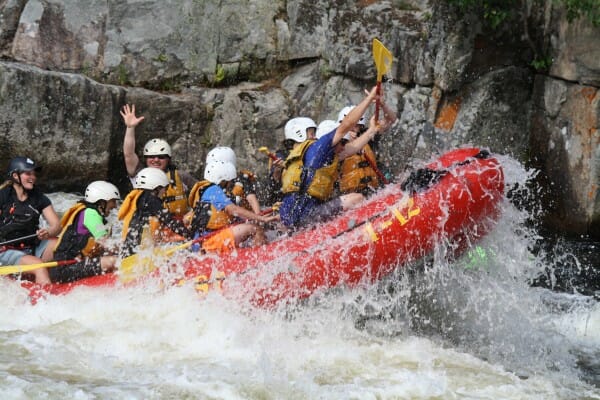 Group of People Fighting Off Waves While Whitewater Rafting on the Penobscot River