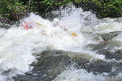 People Whitewater Rafting on the Dead River getting splashed by water