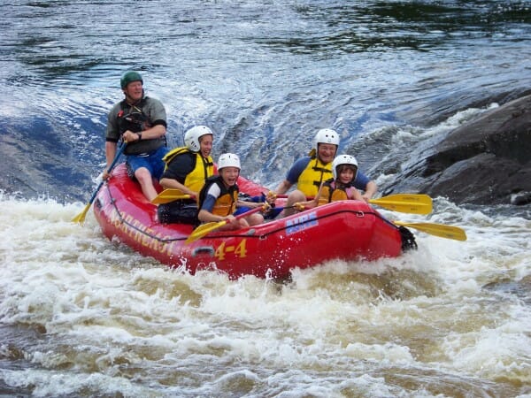 Group of People Laughing While Rafting on a river in Maine