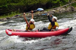 Two People Kayaking on a River in Maine