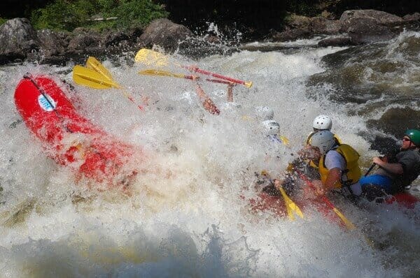 group of people hitting a big rapid whitewater rafting in Maine