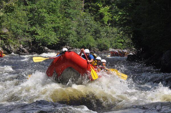 Rough Waters With Group of People on a raft with northeast whitewater in Maine