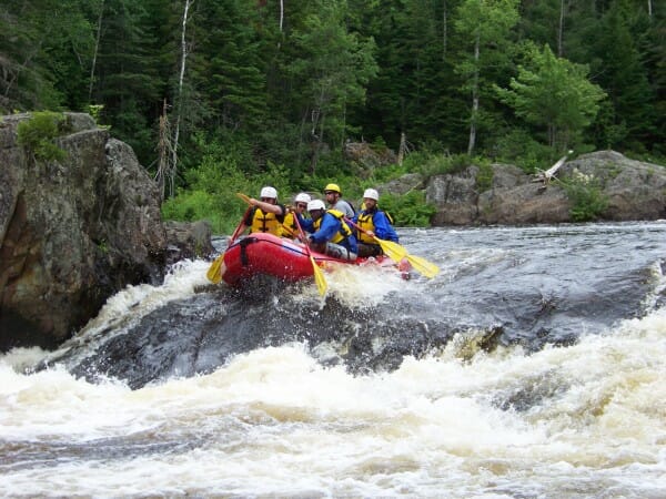Boaters About to Go Through a Wave While Whitewater Rafting in Maine
