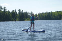 Person Paddleboarding in Maine